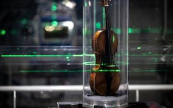 The world's most famous violin, "Il Cannone", made in 1743 and played by the great virtuoso Niccolo Paganini, being examined. AFP/Jean-Philippe Ksiazek