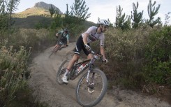 Matt Beers(R) of South Africa rides on his way to win Stage 4 of the 2024 Cape Epic mountain bike race. AFP/Rodger Bosch