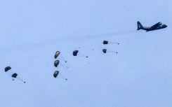 A Royal Jordanian Air Force C-130 Hercules military aircraft releasing parachutes of humanitarian aid over the besieged Palestinian territory. AFP/Jack Guez