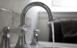 File: Water flows from a tap. AFP/Justin Sullivan/Getty Images