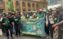 MK Party supporters with their banner outside court