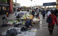 File: An informal vendor sets up his stall. AFP/Michele Spatari