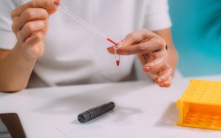 File: Measuring blood glucose levels, conceptual image.