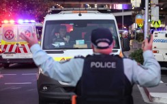An ambulance leaves the crime site outside the Westfield Bondi Junction shopping mall after a stabbing incident. AFP?David Gray