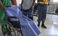 Medics escorting the little girl to the plane.