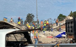 Rescuers are on the scene trying to free the trapped workers. eNCA/Kevin Brandt