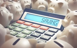 File: An illustration of a calculator with the word saving and piggy banks. KTS/Science Photo Library via AFP