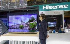 File: A vendor next to a Hisense TV. DYCJ/Imaginechina via AFP