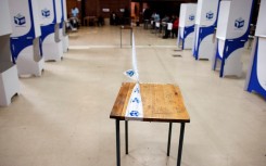 File: Tape of the IEC demarcates a polling station. AFP/Rodger Bosch