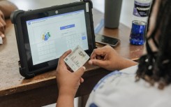An IEC official checks an ID. AFP/Rajesh Jantilal