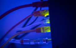 Ethernet cable wires lighting up connected to an internet router modem. Jaap Arriens/NurPhoto via AFP