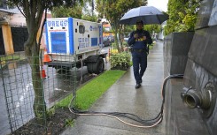 A securitu guard walks next to an electricity generator in Quito amid an electricity crisis sparked by a drought. AFP/Rodrigo Buendia