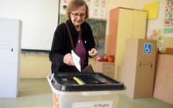 A woman casts her ballot to vote in the first round of the presidential elections, at a polling station in Skopje. AFP/Robert Atanasovski