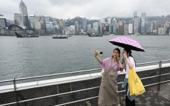 Tourists from mainland China visit the Tsim Sha Tsui waterfront in Hong Kong. AFP/Peter Parks