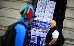 A person points at a poster outside the South African High Commission in central London. AFP/Benjamin Cremel