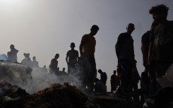 Palestinians gather at the site of an Israeli strike on a camp for internally displaced people in Rafah on May 27, 2024, amid ongoing battles between Israel and the Palestinian Hamas militant group. 