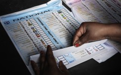 An Electoral Commission of South Africa (IEC) official prepares a ballot to be handed out to a voter. AFP/Gianluigi Guercia