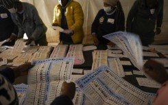IEC) officials sort ballots during counting at Itereleng informal settlement polling station in Pretoria. Phill Magakoe/AFP