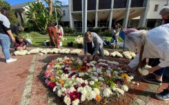 Members of the public laying flowers at the site of the building collapse. eNCA/Kevin Brandt