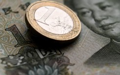 File: A Euro coin and a Chinese yuan banknote. AFP/Kirill Kudryavtsev