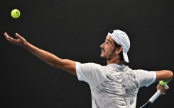 South Africa's Lloyd Harris serves against France's Quentin Halys during their men's singles match on day one of the Australian Open tennis tournament in Melbourne on January 14, 2024.