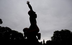 File: A father plays with his son in a park.