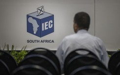 A man watches live voting results at the Independent Electoral Commission (IEC) National Results Center in Midrand on May 31, 2024. 