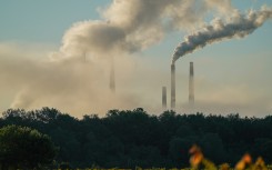File: Pollution spewing from the stacks of a power plant. Jason Whitman/NurPhoto via AFP