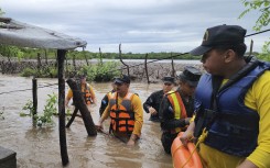 firefighters carrying out rescue work in a flooded area in Nacaome, Valle department, Honduras. AFP/Honduran Firefighters