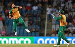 Tabraiz Shamsi (L) celebrates after the dismissal of Afghanistan's Karim Janat (out of frame) during the ICC men's Twenty20 World Cup 2024 semi-final cricket match between South Africa and Afghanistan. AFP/Chandan Khanna