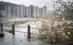 File: Waves of foam and seawater crash into Three Anchor Bay in Cape Town. AFP/Rodger Bosch