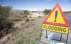 File: A flood warning sign. Dr Neil Overy/NOE/Science Photo Library via AFP