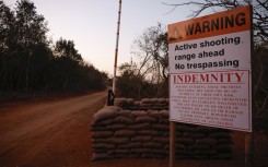 A warning sign at the entrance to a farm where the SAPS detained 95 Libyan nationals. AFP/Phill Magakoe
