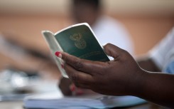 File: A woman holds an Identity book. 