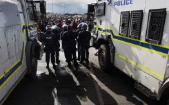 File: Police officers seen at a protest near Cape Town. AFP/Rodger Bosch
