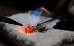 A goldsmith works on gold ornaments at a workshop in Kolkata, India. NurPhoto via AFP/Debajyoti Chakraborty