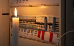 File: A candle next to an electricity meter. AFP/Valerie Dubois/Hans Lucas