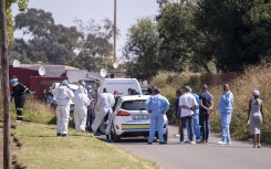 File: Police and forensic officers at a crime scene. AFP/Emmanuel Croset