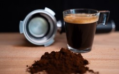 File: A glass of espresso coffee, a portafilter, and some coffee blend. Nikos Pekiaridis/NurPhoto via AFP