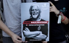  File: Protesters hold a placard as they attend a demonstration in support for NGO Sea Shepherd Conservation Society Canadian founder Paul Watson. AFP/Stephane De Sakutin