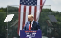  Former US President and Republican presidential candidate Donald Trump speaks behind bulletproof glass during a campaign rally. Peter Zay/AFP