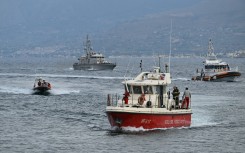 Rescue boats return to Porticello harbor near Palermo, after they found two bodies, on August 21, 2024 two days after the British-flagged luxury yacht Bayesian sank. 