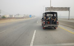 Police officers in a car on a highway in Lahore. Thomas Imo/Photothek Media Lab/dpa Picture-Alliance via AFP