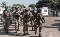 File: SANDF members walk as they take part in a law enforcement operation. AFP/Rajesh Jantilal