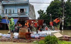 Rescuers deliver water and food on boat to flood victims in Trang Dinh district. AFP/Thu Huong