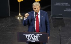 Former US President and Republican presidential candidate Donald Trump clenches his fist as he leaves after speaking during a campaign event. AFP/Rebecca Noble