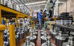 A worker works at a loader transmission mechanism manufacturing company. Costfoto/NurPhoto via AFP
