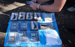 Police officers collecting evidence on a drug trafficking ring dubbed "The Commission". AFP/New South Wales Police