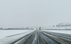 A general view of heavy snowfall on a road to Harrismith from Sterkfontein dam on September 21, 2024. 