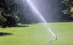 File: A lawn being watered with a hosepipe. Biosphoto via AFP/Frederic Didillon